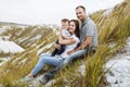 Happy young family near lake, pond. Family enjoying life together at meadow. People having fun in nature. Family bonds Royalty Free Stock Photo