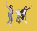 Happy young family with one child jumping together Royalty Free Stock Photo