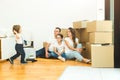 Happy young family, parents daughter and son, unpacking boxes and moving into a new home. funny kids run in with boxes Royalty Free Stock Photo