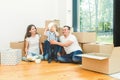 Happy young family, parents daughter and son, unpacking boxes and moving into a new home. funny kids run in with boxes Royalty Free Stock Photo