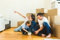 Happy young family, parents daughter and son, unpacking boxes and moving into a new home. funny kids run in with boxes Royalty Free Stock Photo