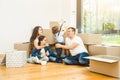 Happy young family, parents daughter and son, unpacking boxes and moving into a new home. funny kids run in with boxes Royalty Free Stock Photo