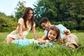 Happy Young Family In Park. Parents And Kids Having Fun, Playing Royalty Free Stock Photo