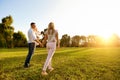 Happy young family in the park at sunset. Royalty Free Stock Photo
