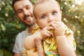 The happy young family during picking apples in a garden outdoors Royalty Free Stock Photo