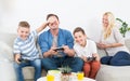 Happy young family playing videogame On TV.