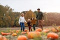 Happy young family in pumpkin patch field Royalty Free Stock Photo