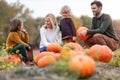 Happy young family in pumpkin patch field Royalty Free Stock Photo