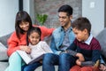 Happy young family reading a book together