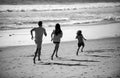 Happy young family run and jump on summer beach. Child with parents running and jumping. Concept of friendly family and Royalty Free Stock Photo