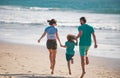 Happy young family run and jump on summer beach. Child with parents running and jumping. Healthy holiday and family Royalty Free Stock Photo