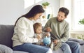 Happy young family saving money in piggy bank Royalty Free Stock Photo