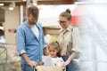 Happy Young Family Shopping in Supermarket Royalty Free Stock Photo