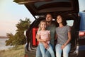 Happy young family sitting in car trunk Royalty Free Stock Photo