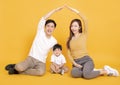 Happy young family sitting on floor with home concept Royalty Free Stock Photo