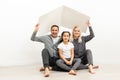 happy young family sitting on floor with home concept Royalty Free Stock Photo