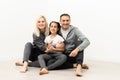 happy young family sitting on floor with home concept Royalty Free Stock Photo