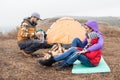 Happy young family sitting near tent Royalty Free Stock Photo