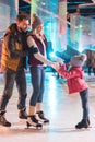 happy young family skating together