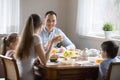 Happy family with kids having breakfast at home Royalty Free Stock Photo