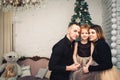 Happy young family in stylish clothes at christmas time. Royalty Free Stock Photo