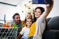 Happy young family take a self portrait with smart phone. Royalty Free Stock Photo