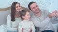 Happy young family taking selfies on sofa with tablet Royalty Free Stock Photo