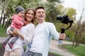 Happy young family taking video selfies with her camera on the gimbal steadycam