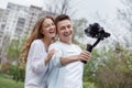 Happy young family taking video selfies with her camera on the gimbal steadycam