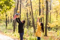 Happy young family with their daughter spending time outdoor in the autumn park. Royalty Free Stock Photo