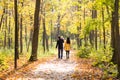 Happy young family with their daughter spending time outdoor in the autumn park Royalty Free Stock Photo