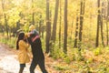 Happy young family with their daughter spending time outdoor in the autumn park Royalty Free Stock Photo