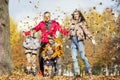 Happy young family with three children in the autumn park. Love and tenderness. Walk in the golden season Royalty Free Stock Photo