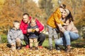 Happy young family with three children in the autumn park. Love and tenderness. Walk in the golden season Royalty Free Stock Photo