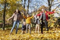 Happy young family with three children in the autumn park. Love and tenderness. Walk in the golden season Royalty Free Stock Photo