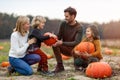 Happy young family in pumpkin patch field Royalty Free Stock Photo