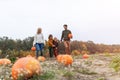 Happy young family in pumpkin patch field Royalty Free Stock Photo