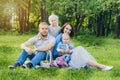 Family with two children rest in the summer garden