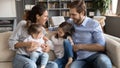 Happy young family with two kids having fun in living room Royalty Free Stock Photo