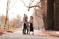 Happy young family with two little children walking and having fun in autumn park on sunny day Royalty Free Stock Photo