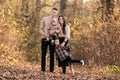 Happy young family with two little children walking and having fun in autumn park on sunny day Royalty Free Stock Photo