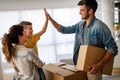 Happy young family unpacking cardboard boxes at new home Royalty Free Stock Photo