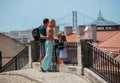 Happy young family on vacations look at famous Lisbon bridge Royalty Free Stock Photo