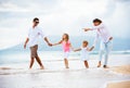 Happy young family walking on the beach Royalty Free Stock Photo