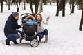 Happy young family walking in the park in winter Royalty Free Stock Photo