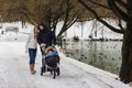 Happy young family walking in the park in winter Royalty Free Stock Photo