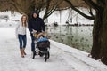 Happy young family walking in the park in winter Royalty Free Stock Photo