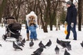 Happy young family walking in the park in winter Royalty Free Stock Photo