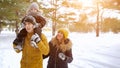 Happy young family are walking in winter city park together. Royalty Free Stock Photo