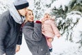 happy young family walks with baby on winter street, mom, dad, c Royalty Free Stock Photo